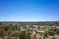 Aerial view of trees, roads, and suburban houses in Ballarat against the cloudless blue sky.