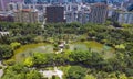 Aerial view of trees in Taipei park garden and reflection of skyscrapers buildings. Green area in smart urban city at noon, Taiwan Royalty Free Stock Photo