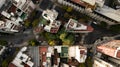 Aerial view of triangle shaped set of the buildings surrounded by streets, pedestrian passing, and autumn trees