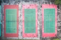 Aerial view of triple outdoor green and red hard tennis court Royalty Free Stock Photo