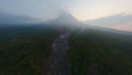 Aerial view tropical dark morning forest canyon frozen volcanic lava smoke eruption