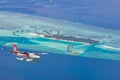 Aerial view of a tropical island in the Indian ocean with seaplane approaching, Maldives