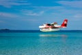 Aerial view of a tropical island in the Indian ocean with seaplane approaching, Maldives Royalty Free Stock Photo