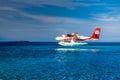 Aerial view of a tropical island in the Indian ocean with seaplane approaching, Maldives Royalty Free Stock Photo