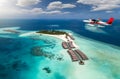 Aerial view of a tropical island with seaplane approaching, Maldives