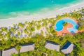 Aerial view of tropical sandy beach with palms and umbrellas at sunny day. Summer holiday on Indian Ocean, Zanzibar, Africa. Royalty Free Stock Photo