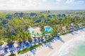 Aerial view of tropical sandy beach with palms and umbrellas at sunny day. Summer holiday on Indian Ocean, Zanzibar, Africa. Royalty Free Stock Photo