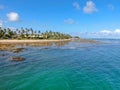 Aerial view of tropical white sand beach, palm trees and turquoise clear sea water in Praia do Forte Royalty Free Stock Photo