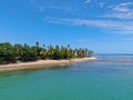 Aerial view of tropical white sand beach, palm trees and turquoise clear sea water in Praia do Forte Royalty Free Stock Photo