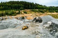 Aerial view of Truck excavator in open sand quarry rubble in Finland