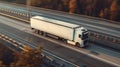 Aerial view on truck while running along super hight way. Large freight transporter semi-truck on the road