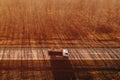 Aerial view of truck with waste paper loaded in wagon driving through wooded autumn scenery