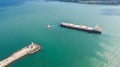 ug boat assisting big cargo ship. Large cargo ship enters the port escorted by tugboat Royalty Free Stock Photo