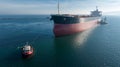 Aerial view of tug boat assisting big cargo ship. Large cargo ship enters the port escorted by tugboats Royalty Free Stock Photo