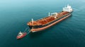 Aerial view of tug boat assisting big oil tanker. Large oil tanker ship enters the port escorted by tugboat Royalty Free Stock Photo