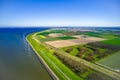 Aerial view of tulips fields in Netherlands with wind mills and blue sea