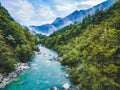 Aerial view of the turquoise blue Soca river and wooden bridge near Bovec in the Julian Alps in Slovenia. Royalty Free Stock Photo