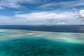 Aerial view of turquoise colored ocean and reef