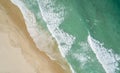 Aerial view of turquoise sea, beach, and yellow sand on Tallebudgera Beach