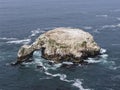 Aerial view of a turtle-shaped rock island in a bay of the Pacific Ocean Royalty Free Stock Photo