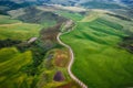 Aerial view of Tuscany rural landscape, road on rolling landscape at sunset, Agriturismo Baccoleno, Asciano, Italy