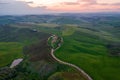 Aerial view of Tuscany rural landscape, road on rolling landscape at sunset, Agriturismo Baccoleno, Asciano, Italy
