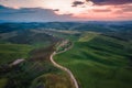 Aerial view of Tuscany rural landscape, road on rolling landscape at sunset, Agriturismo Baccoleno, Asciano, Italy