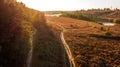 Aerial view of dirty road among the forest and trees. Sunset field in Ukraine Royalty Free Stock Photo