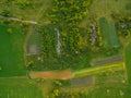 Aerial view of twisting road among the forest and trees. Sunset field in Lithuania Royalty Free Stock Photo