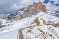 Aerial view of twisting road in a mountains of Italy, Dolomites, is serpentine among the snow-covered hills, is famous