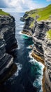 Aerial view of two cliff gaps separated by the ocean on the Faroe Islands