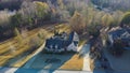 Aerial view two story suburban house with large lot size near residential street in lush greenery area with low density housing Royalty Free Stock Photo