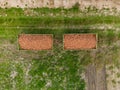 Aerial view of two trailers with onions from above in a field Royalty Free Stock Photo