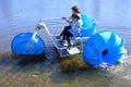 Aerial view of two young girls  riding on a big wheel aqua bike water tricycle Royalty Free Stock Photo