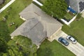 Aerial view of typical contemporary american private house with roof top covered with asphalt shingles and green lawn on