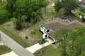 Aerial view of typical contemporary american private house with roof top covered with asphalt shingles and green lawn on