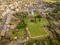 Aerial view of a typical English village with the old Church seen at the centre of the village with its large cemetery.