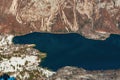 Aerial view of Ukanc, small settlement at western shoreline of lake Bohinj during winter in Slovenian national park Triglav,
