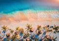 Aerial view of umbrellas, palms on the sandy beach of ocean Royalty Free Stock Photo