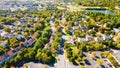 Aerial view of upscale residential area, gated community street real estate with single family homes. Autumn sunny day