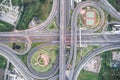Aerial view of urbal highway intersection road with green exercise background Royalty Free Stock Photo