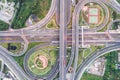 Aerial view of urbal highway intersection road with green exercise background