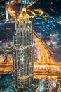 Aerial View Of Urban Background Of Illuminated Cityscape With Tower And Skyscraper In Dubai. Street Night Traffic In Royalty Free Stock Photo