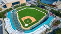 Aerial View of Urban Baseball Stadium with Vibrant Field and Cityscape Royalty Free Stock Photo