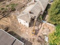 Aerial view of urban demolition site with working heavy machinery