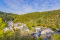 Aerial view of the valley with hills with lush green trees, houses, street with parked cars in Esch-sur-Sure village Royalty Free Stock Photo