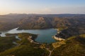 Aerial view of the valley, olive fields and Embalse de Forata reservoir during sunset. Summer in Spain