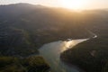 Aerial view of the valley, olive fields and Embalse de Forata reservoir during sunset. Summer in Spain