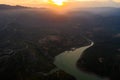 Aerial view of the valley, olive fields and Embalse de Forata reservoir during sunset. Summer in Spain