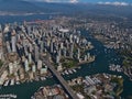 Aerial view of Vancouver downtown, Canada with False Creek bay, marinas, stadium and skyline with tall skyscrapers.